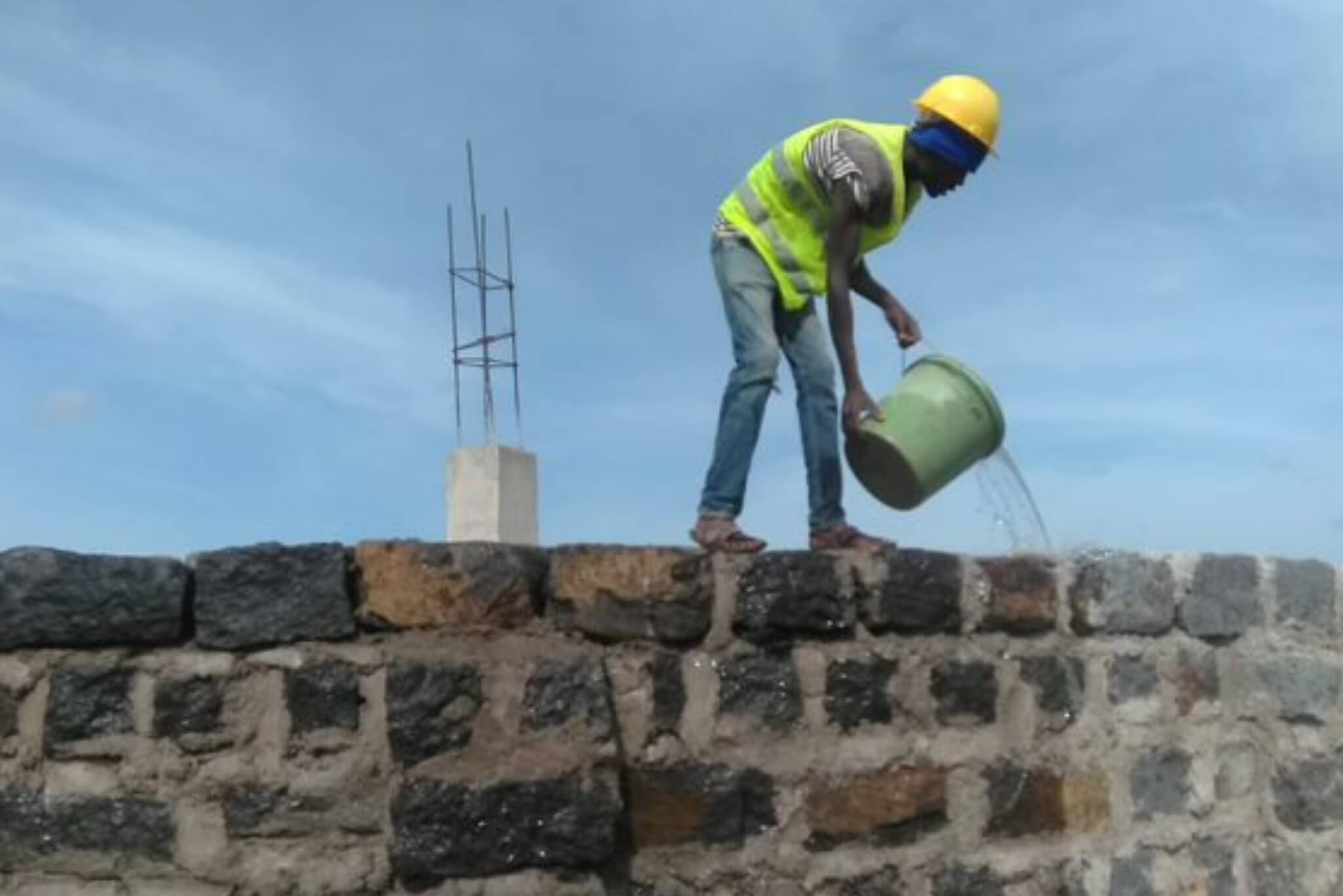Worker pouring water